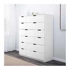 a white chest of drawers in a room