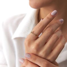 Our new lovely minimalist 14K solid gold love script ring. Simple and elegant. 14K solid gold is perfect for everyday use since it will not tarnish, and you don't have to worry about contact with conditioners or water. A perfect ring to stack as well.★ Ring Features• Gold Kt: 14Kt Solid Gold (All pieces are stamped for authenticity)• Available Gold Colors: Yellow Gold• Love Script Dimensions: 15.0 mm by 6.0 mm / 0.59 Inch by 0.24 Inch• Band Width 1.20 mm