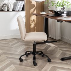 an office chair sitting on top of a hard wood floor next to a wooden desk