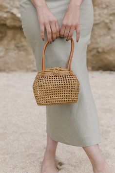 The model holding Tenganan Basket clasp Handbag. Small, chic, and Handmade in Tenganan, Bali using natural Ata reed. - Saffron and Poe Beg Anyaman, Handbag Poses, Handbag Photoshoot, Basket Handbag, Rattan Style, Handwoven Throw, Holiday Photoshoot, Woven Bags, Handmade Handbag