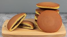 a stack of cookies sitting on top of a wooden cutting board next to each other