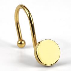 a gold nose ring with a round ball on the end, and a circular disc in the middle