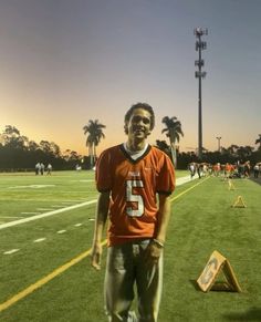 a man standing on top of a football field