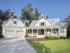 a large white house with two garages