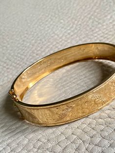 Made in 1962 - Wide Hinged Bangle in 18k gold - Etched Curls Pattern - Stockholm, Sweden - Size 7 Stunning vintage hinged bangle crafted in 18k yellow gold. Bangle was made in 1962 by maker GFP active 1945-1968. Bracelet has full Swedish hallmarks for maker, year, location and gold purity. By hand, the goldsmith etched a wonderful swirling curl pattern on one side of the bangle and polished the other side - you can wear her either way - a two in one! She is oval shaped measuring 7 inches inside Hallmarked Yellow Gold Cuff Bracelet For Formal Occasions, Formal Hallmarked Yellow Gold Cuff Bracelet, Formal Yellow Gold Hallmarked Cuff Bracelet, Formal Heirloom Yellow Gold Cuff Bracelet, Elegant Ceremonial Bangle With Polished Finish, Hallmarked Yellow Gold Bracelet For Ceremonial Occasions, Ceremonial Hallmarked Yellow Gold Bracelet, Heirloom Yellow Gold Cuff Bracelet For Ceremonial Occasions, Ceremonial Heirloom Yellow Gold Cuff Bracelet