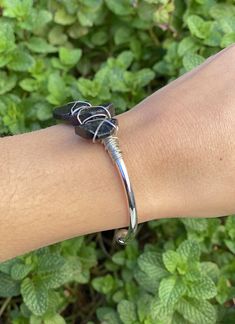 You deserve to look and feel your best. You deserve to find your inner peace. You deserve to radiate happiness, love, and light. This Black Tourmaline Bracelet is the perfect way for you to do all of these things! Wear it when you are feeling low. Wear it when you are in need of some extra vibes of grounded energy. Wear it when you want to be in that coveted "zone." Consciously created with intention. You deserve jewelry that's as beautiful as you are. These bangle cuffs are perfect for your eve Adjustable Spiritual Cuff Bracelet With Gemstone, Adjustable Spiritual Gemstone Cuff Bracelet, Spiritual Wire Wrapped Cuff Bangle Bracelet, Spiritual Wire Wrapped Bangle Cuff Bracelet, Spiritual Adjustable Stackable Bangle, Spiritual Wire-wrapped Bangle Cuff Bracelet, Adjustable Gemstone Cuff Bracelet For Healing, Adjustable Spiritual Cuff Bracelet With Natural Stones, Adjustable Stackable Spiritual Bangle