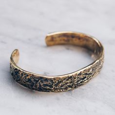 Brass Abstract Band Bracelet that is slightly adjustable. Available in women's and men's lengths. A rustic gold cuff bracelet style adds the perfect touch dressed up or down. Bracelet Size Medium (Women's) Large (Men's) Available in 925 Sterling Silver https://etsy.me/3i4Htje A note about brass jewelry and oxidization: Verdigris is the common name for a green coloring obtained through the application of acetic acid to copper plates or the natural patina formed when copper, brass or bronze is wea Adjustable Hammered Bronze Bracelets, Adjustable Gold Band Cuff Bracelet, Adjustable Gold Engraved Wristband, Adjustable Antique Gold Metal Cuff Bracelet, Adjustable Engraved Gold Wristband, Adjustable Rustic Bronze Bracelets, Rustic Adjustable Bronze Bracelets, Rustic Adjustable Bronze Bracelet, Rustic Gold Bracelets As Gift