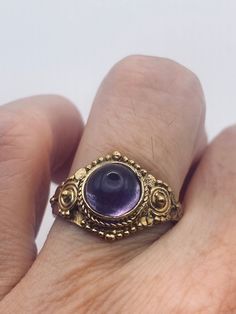 Deep purple amethyst stone  Lovely vintage golden bronze setting Size 7.5  Our jeweler can custom re size this for a $20 fee.  All rings are shipped in a nice gift box.   Check out our over a THOUSAND great reviews Engraving is $4 per letter and is not always perfect depending on the piece. It can take a few days if the jeweler is busy. This is payable to Paypal Judithsltd@gmail.com Vintage Amethyst Ring Gold, Gold Spiritual Rings With Bezel Setting, Spiritual Gold Rings With Bezel Setting, Gold Brass Crystal Ring Gift, Gold Brass Crystal Ring For Gifting, Brass Jewelry With Bezel Setting For Gift, Antique Crystal Ring As Gift, Vintage Yellow Gold Amethyst Ring, Victorian Style Purple Amethyst Ring For Gift