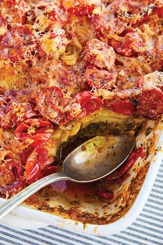 a close up of a casserole dish with meat and vegetables in it on a table