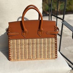 Elevate your style with the Stacey Woven Wicker Handbag, a charming blend of elegance and bohemian flair that effortlessly complements any outfit. Handcrafted with love, its unique texture and spacious design invite you to carry your essentials in a piece that radiates warmth and timeless beauty, making every moment feel special. 11" x 3.5" x 9" Woven Rattan. Vegan leather trim High-end Satchel With Leather Handles For Errands, High-end Shoulder Bag With Leather Handles For Errands, Designer Tan Bags With Leather Handles, High-end Leather-handled Tote Satchel, High-end Tote Satchel With Leather Handles, High-end Satchel With Leather Handles In Tote Style, High-end Satchel With Leather Handles Tote Shape, High-end Leather Handles Satchel Tote, Designer Tan Rectangular Satchel