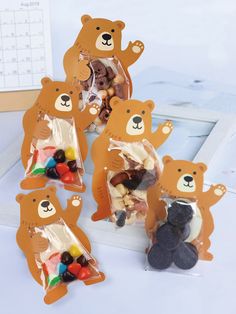 there are many bear candies in the bag and on the table next to each other