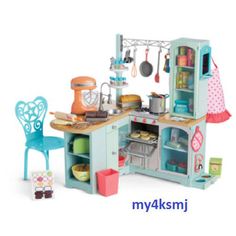 a doll house kitchen with furniture and accessories