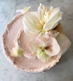 a cake with frosting and flowers on top