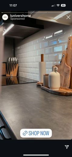 a kitchen counter with cutting boards and knives on it