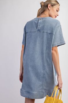 Details Brand: Easel Denim Tunic Dress Mineral Wash Panel Detailing Rounded Neckline Slightly Dropped Shoulders Short Sleeves Front Pockets Snap Back Button Closure Material and Care 97% Cotton 3% Spandex Hand Wash Cold Hang or Line Dry Measurements of Garment Bust of the garment is measured armpit to armpit and then doubled. Length of the garment is measured from the top of the shoulder to the bottom of the hem line. Sleeve Length of the garment is measured from the top part of the shoulder sea Washed Blue Cotton Denim Dress With Button Closure, Washed Blue Denim Dress With Button Closure, Relaxed Fit Washed Blue Denim Dress With Button Closure, Casual Washed Chambray Denim Dress, Casual Washed Blue Short Sleeve Denim Dress, Casual Washed Blue Mini Denim Dress, Washed Blue Chambray Denim Dress, Casual Washed Blue Denim Dress With Short Sleeves, Trendy Light Wash Relaxed Fit Denim Dress