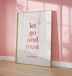 a pink room with a framed poster on the wall that says let go and trust