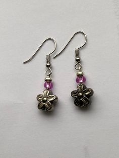 These cute earrings are perfect for springtime and summertime! They are composed of a plastic flower bead and a small pink bead. Earring wire is stainless steel and hypo-allergenic! Summer Flower Shaped Metal Earrings, Nickel-free Flower Earrings For Spring, Pink Flower Metal Earrings, Pink Flower-shaped Metal Earrings, Nickel-free Flower Earrings For Summer, Nickel-free Flower Earrings For Jewelry Making In Summer, Nickel-free Flower Earrings For Jewelry Making, Pink Hypoallergenic Adjustable Beaded Earrings, Adjustable Hypoallergenic Pink Beaded Earrings