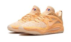 the nike zoom basketball shoe is shown in light orange and white colors, with gold accents