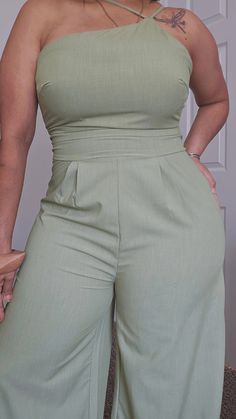 Enchanting and elegant, our Sage One-Shoulder Jumpsuit is a must-have for any fashion-forward lady. Its lightweight blend of 65% viscose, 30% polyester, and 5% elastane offers supreme comfort while the distinct one-shoulder design with delicate straps and beautifully pleated waistband adds a touch of femininity. With its full-length and wide leg silhouette, zipper in the back for a better fit, this jumpsuit flatters the figure, giving a slim and captivating appearance. The unique asymmetry and a One Shoulder Jumpsuit, Tube Top Dress, Single Button Blazer, Color Block Top, Classic Blazer, Shoulder Design, Pink Sweatshirt, Bohemian Dress, Blazer Buttons