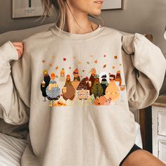 Fall Chicken Sweatshirt, Halloween Chicken Sweatshirt, Women Chicken Sweatshirt, Pumpkin Chickens, Animal Sweatshirt,Fall Farmer Farm Shirt Thank you so much for taking the time to browse my shop. Please feel free to reach out if you have any questions before or after purchasing.  💖 🎨Warning: On products with a print chart in the listing, metallic print colors are printed as matte. We design and cut each graphic out with a soft touch, use matte vinyl and a heat press. The result will last for Relaxed Fit Cartoon Print Top For Fall, Fall Long Sleeve Tops With Funny Print, Cute Fall Sweatshirt With Funny Print, Cute Cartoon Print Fall Sweatshirt, Funny Print Long Sleeve Sweatshirt For Fall, Long Sleeve Sweatshirt With Funny Print For Fall, Cute Cartoon Print Sweatshirt For Fall, Fall Sweatshirt With Funny Print And Relaxed Fit, Funny Print Long Sleeve T-shirt For Fall