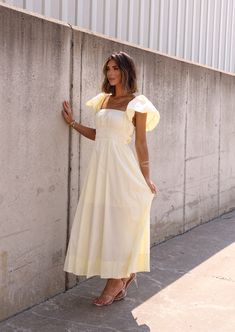 Look and feel stunning in our Maddie Midi Dress, perfect for any occasion! The soft yellow hue will brighten up your day, while the elastic waist ensures a comfortable fit. Wear it on or off the shoulder for a versatile look! Fabric 65% cotton, 35% polyester Cotton Ruched Maxi Dress For Day Out, Cotton Maxi Dress With Ruched Detail For Day Out, Cotton Ruched Midi Dress For Day Out, Spring Solid Cotton Maxi Dress, Cotton Maxi Dress With Smocked Bodice For Day Out, Casual Cotton Ruched Maxi Dress, Yellow Smocked Bodice Midi Dress, Yellow Midi Dress With Smocked Bodice, Cotton Midi Dress With Smocked Back For Brunch