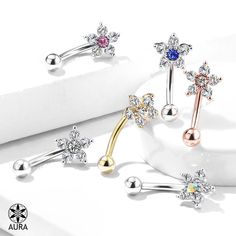 "Dazzling Flower Crystal Curved Barbell - Eyebrow Ring  Size Thickness: 16GA (1.2mm)  Length: 1/4\" (6mm) Ball Size: 6.5mm  Materials: 316L Surgical Steel & Brass Plating: Rhodium/14K Gold Sold by the Piece Choose Your Color: Clear Clear/Aurora Borealis Clear/Blue Clear/Pink Gold/Clear Rose Gold/Clear Visit our main website & boutique www.WearAura.com Follow us on Facebook! www.facebook.com/wearAURA Follow us on Instagram www.instagram.com/wear_aura * * * Gift Package: All items come beautifully Piercing Eyebrow, Curved Eyebrows, Opalite Crystal, Barbell Piercing, Eyebrow Ring, Flower Top, Enamel Bracelet, Sell Gold, Blue Gems