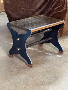 a small wooden table sitting on top of a carpeted floor