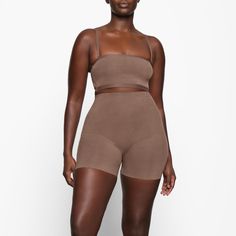 A mid-thigh short with deep low back that makes it perfect backless shapewear option for low cut clothing. Smooths and sculpts thighs and hips with silky smooth compression. | SKIMS Low Back Short | Medium Neutral | Sheer Sculpt Backless Shapewear, Thigh Sculpting, Above The Knee Shorts, Mid Thigh Shorts, High Neck Bodysuit, Low Back Dresses, Scoop Neck Bodysuit, Cut Clothes, Cami Bodysuit