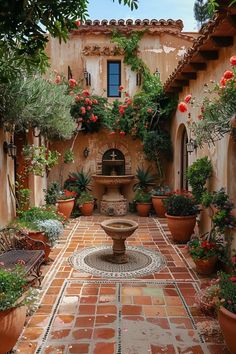 an outdoor courtyard with potted plants and a fountain