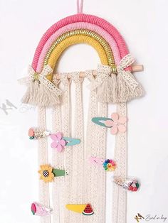 a wall hanging made out of macrame yarn and fabric with flowers, birds, and rainbows on it