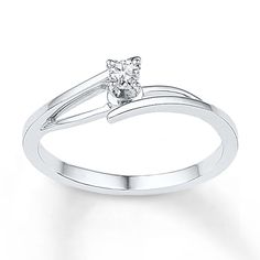 a white gold ring with a single diamond