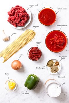 ingredients to make spaghetti sauce laid out on a white counter top, labeled in italian words