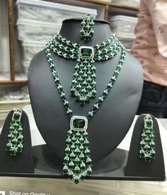 Crystal Emerald CZ Diamonds Choker Necklace Earrings Jewelry, Long Bridal Indian Jewelry, Bridal Wedding Handmade Jewelry Green CZ Tikka Set ITEM DESCRIPTION Metal        = Silver Plated Occasion  = Wedding ,Party Wear, Bridal Color        =  As per your order Size          = Necklace Length = 28 CM- Choker Necklace - 18 CM Earrings/Studs = 7 CM  Tika = 10 CM 100% Satisfaction Guarantee: 1 Year Warranty, Long Lasting Plating, High-Quality Stones Occasion: Perfect choice for any Indian occasion. Green Bridal Necklace With American Diamonds, Green American Diamond Bridal Necklace For Wedding, Heavy Emerald Jewelry For Wedding, Traditional Crystal Bridal Sets, Traditional Crystal Bridal Sets For Celebration, Green American Diamond Bridal Necklace, Hand Set Emerald Jewelry Sets For Wedding, Wedding Green American Diamond Jewelry Sets, Elegant Heavy Green Bridal Sets