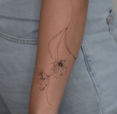 a woman with a flower tattoo on her arm