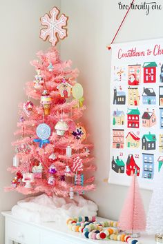 a pink christmas tree with candy decorations on it