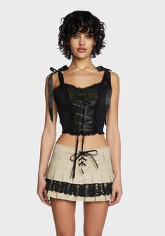 even the leaves fall for you! This cropped corset top has a twill construction, adjustable ribbon shoulder and lace-up front and back ties, ruffled lace trim, and a side zip closure. Cotton Corset Belt For Spring, Spring Underbust Crop Top With Straps, Fitted Ruffle Crop Top For Fall, Spring Cropped Corset With Corset Back, Fitted Ruffled Crop Top For Fall, Gothic Corset For Spring, Fitted Lace Crop Top With Ruffles, Fall Fitted Ruffles Crop Top, Fitted Ruffled Corset In Balletcore Style