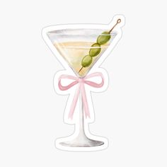 a martini glass with an olive sticker on the top and pink ribbon around it