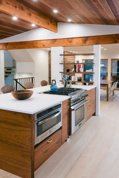 a kitchen with an island, stove and sink