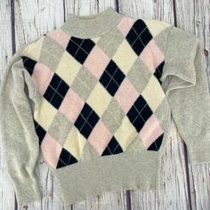 "Cozy up in this beautifully made, knitted vintage Arlando brand pullover sweater. It's made with lambswool and angora so it's super soft, both in look and feel. Diamond pattern in baby pink, black, off-white, and grey, with wide grey ribbed cuffs and waist. Vintage fit with drop shoulders, lightweight shoulder pads (which can be removed), and full / slightly puffy sleeves. Excellent vintage condition. Tag - Size Small Petite.  (Vintage sizes may vary from today's modern sizing, so please refer to measurements to ensure correct fit.) Measurements are taken with garment laid flat. Waist: 14-20\" Length: 23\" Chest: 20\" Shoulder: 7\" Sleeve: 21\" Fiber: 70% Lambswool, 20% angora rabbit hair, 10% nylon Detailing: Grey ribbed cuffs, neck, and waist. Care: dry clean About my vintage items: Bec Winter Argyle Pattern Tops, Cozy Argyle Pattern Long Sleeve Sweater, Cozy Long Sleeve Argyle Sweater, Vintage Fall Sweater For Cold Weather, Fall Vintage Sweater For Cold Weather, Retro Crew Neck Sweater For Layering, Winter Argyle Knit Sweater, Fitted Argyle Pattern Tops For Winter, Winter Argyle Pattern Crew Neck Sweater