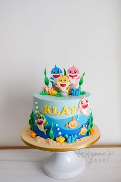 there is a cake that has been decorated with fish and sea creatures on it's sides