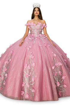 a woman in a pink ball gown with flowers on the skirt and tiara is standing