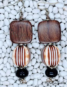 Bulahan Wood in Square Shape suspended from a Vintage Lucite Cube Bead. The Bead is a Washed Finish in Ivory and Brown Etchings.  Etched Wood Bead Embellishment. Antique Brass Ear Wire and can be converted to a Clip On. Brown Dangle Jewelry With Black Beads, Brown Round Beads Earrings For Beach, Brown Round Beaded Earrings For Beach, Elegant Wooden Beads Jewelry For Beach, Colorful Beaded Brown Earrings For Beach, Beach Beaded Earrings With Colorful Beads, Brown Beaded Earrings For The Beach, Brown Beaded Earrings For Beach, Brown Round Bead Earrings For The Beach