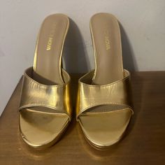 Gold Mules With A Platform Never Worn Gold Platform Heels With Almond Toe, Gold Almond Toe Sandals Medium Width, Gold Synthetic Mules For Party, Gold Almond-toe Sandals Medium Width, Trendy Gold Slip-on Heels, Gold Medium Width Slip-on Heels, Casual Gold High Heels, Gold Platform Mules For Spring, Gold Slip-on Heels For Spring