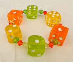 "This lucky dice bracelet is your personal good luck charm. I took real dice in translucent Lemon yellow, lime green and tangerine orange dice and drilled holes and added matching faceted beads in shade of citrus for interest and sparkle. Made with jewelry quality stretch cord, 7\" around I can make custom sizes (depending on my current supplies) and color combos, just send me a message and I'll get right back to you." Dice Bracelet, Orange Accessories, Fashion Words, Yellow Accessories, Yellow Lime, Cute Slippers, Yellow Jewelry, Lucky Bracelet, Tangerine Orange