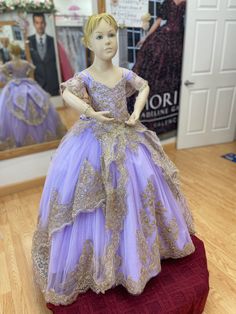 Mini Quinceañera dress Lilac/Gold. This is the mini version of style PR30118 from the Princesa Collection by Ariana Vara. You may request your mini version from any of the Quinceañeras collection such as Princesa, MORI LEE and House of Wu. Please email us for more details. Please note that fabric colors may be slightly different from each monitor and in person. Elegant Purple Dress-up Gown, Elegant Purple Gown For Dress-up, Elegant Purple Pageant Dress, Elegant Short Sleeve Pageant Gown, Quince Lilac, Dress Lilac, Mori Lee, Lilac Dress, Quinceanera Dresses