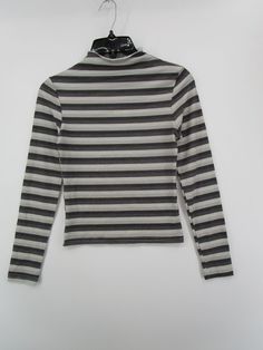 White Ribbed Funnel Neck Top, White High Neck Cotton Top, Trendy High Neck Top, Trendy Cotton Top With Ribbed Collar, Fitted Striped Tops With Ribbed Collar, Winter Striped Stretch Tops, Striped Stretch Tops For Winter, Trendy White Top With Ribbed Collar, Trendy White Tops With Ribbed Collar