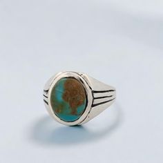 Introducing the Weeping Mary ring, a vintage-inspired piece crafted from sterling silver. This artisan ring boasts an intricate, vintage-style cast design, giving it a touch of timeless elegance. At its heart lies a mesmerizing green-toned Kingman turquoise cabochon, known for its unique and captivating beauty. Sized at 11, this ring ensures a comfortable fit while making a bold and stylish statement. Features Handcrafted sterling silver: Beautifully designed with a vintage touch. Green Kingman Handmade Classic Turquoise Sterling Silver Ring, Handmade Classic Sterling Silver Turquoise Ring, Classic Adjustable Turquoise Ring In Sterling Silver, Classic Turquoise Oval Cabochon Jewelry, Classic Turquoise Signet Ring As Gift, Vintage Sterling Silver Nickel-free Signet Ring, Vintage Nickel Free Sterling Silver Signet Ring, Classic Handmade Turquoise Ring For Anniversary, Vintage Nickel-free Sterling Silver Signet Ring