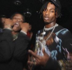 two young men standing next to each other in front of some bubbles and confetti