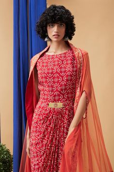 Red crepe dress with bandhej print. Comes with a net cape.
Components: 2
Pattern: Printed
Type Of Work: Bandhej
Neckline: Round
Sleeve Type: Dress: Sleeveless, Cape: Flared Sleeves
Fabric: Dress: Crepe, Cape: Net
Color: Red
Other Details: 
Attached lining
Approx Product Weight: 1 Kg
Closure: Dress - Back zip
Occasion: Party - Aza Fashions Festive Summer Dress With Cape Sleeves, Festive Maxi Dress With Cape Sleeves, Fitted Dress With Cape Sleeves For Festive Occasions, Fitted Cape Sleeve Festive Dresses, Festive Fitted Dress With Cape Sleeves, Traditional Dresses With Cape Sleeves For Summer, Traditional Summer Dresses With Cape Sleeves, Georgette Bandhani Print Dresses For Party, Traditional Fitted Dress With Cape Sleeves