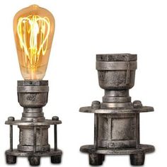 two light bulbs sitting next to each other on top of metal bases with wheels and spokes